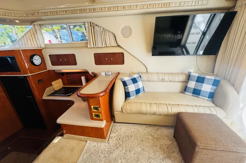 Slide: The Image of Interior of 2000 Sea Ray 400 Sedan Bridge with sofa, TV, and kitchenette. - 33