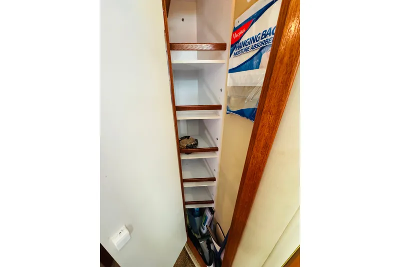 Slide: The Image of Storage shelves inside a 2000 Sea Ray 400 Sedan Bridge yacht. - 41
