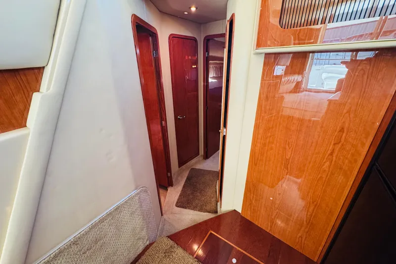 Slide: The Image of Interior hallway of 2000 Sea Ray 400 Sedan Bridge yacht with wooden finishes. - 42