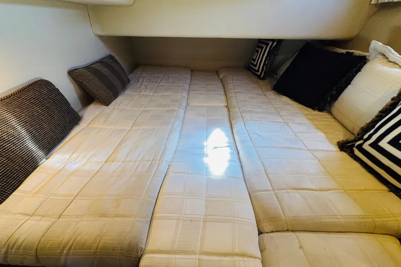 Slide: The Image of Interior cabin of 2000 Sea Ray 400 Sedan Bridge with cozy bedding and pillows. - 44