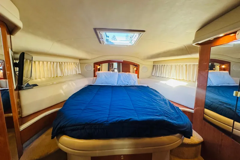 Slide: The Image of Luxurious cabin interior of 2000 Sea Ray 400 Sedan Bridge yacht with cozy bedding. - 45