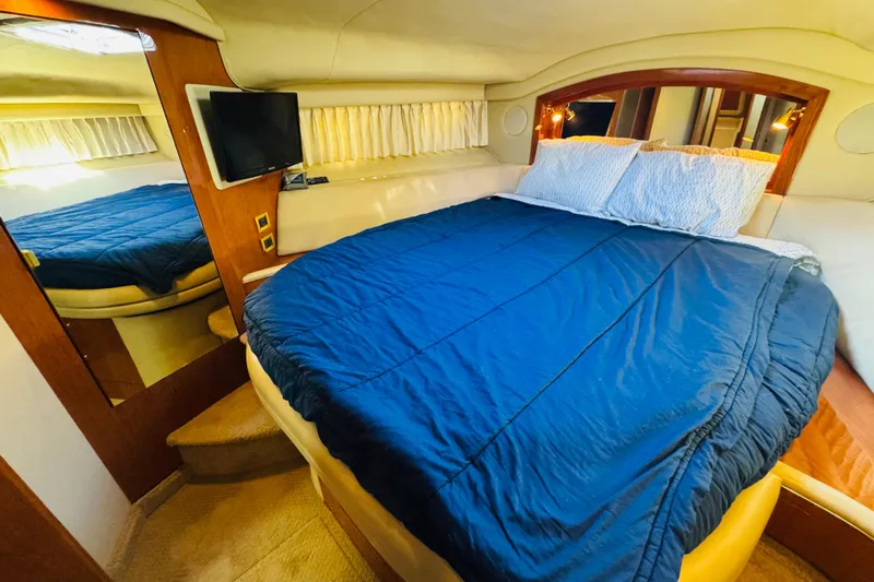 Slide: The Image of Luxurious bedroom interior of 2000 Sea Ray 400 Sedan Bridge yacht with cozy bedding. - 46