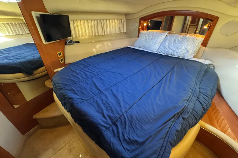 Slide: The Image of Luxurious bedroom interior of 2000 Sea Ray 400 Sedan Bridge yacht with cozy bedding. - 48