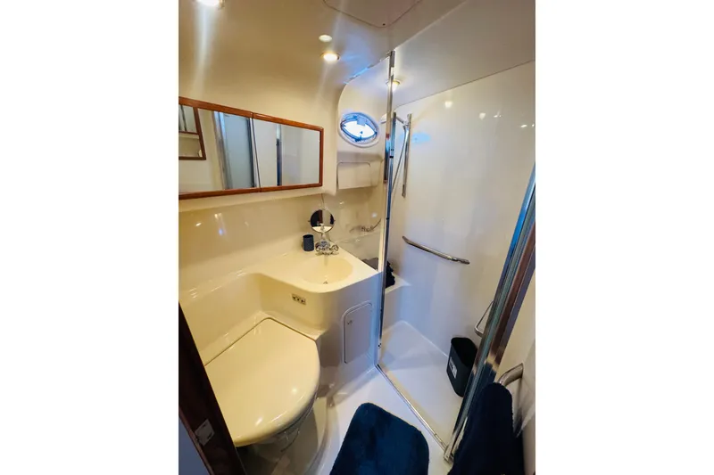 Slide: The Image of Luxurious bathroom in 2000 Sea Ray 400 Sedan Bridge yacht with shower and vanity. - 49