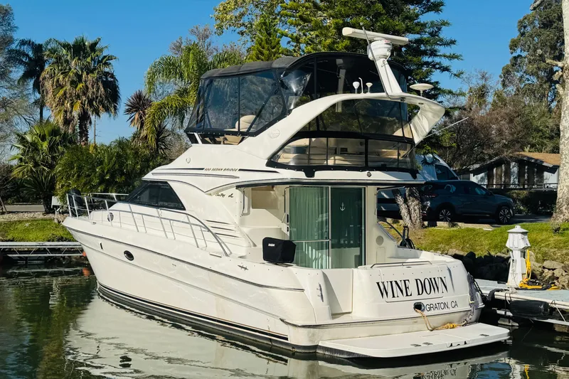 Slide: The Image of 2000 Sea Ray 400 Sedan Bridge yacht docked, featuring sleek design and luxurious amenities. - 5