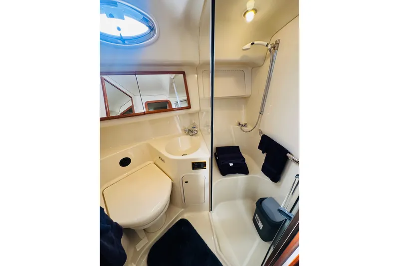 Slide: The Image of Luxurious bathroom in 2000 Sea Ray 400 Sedan Bridge yacht with shower and sink. - 50