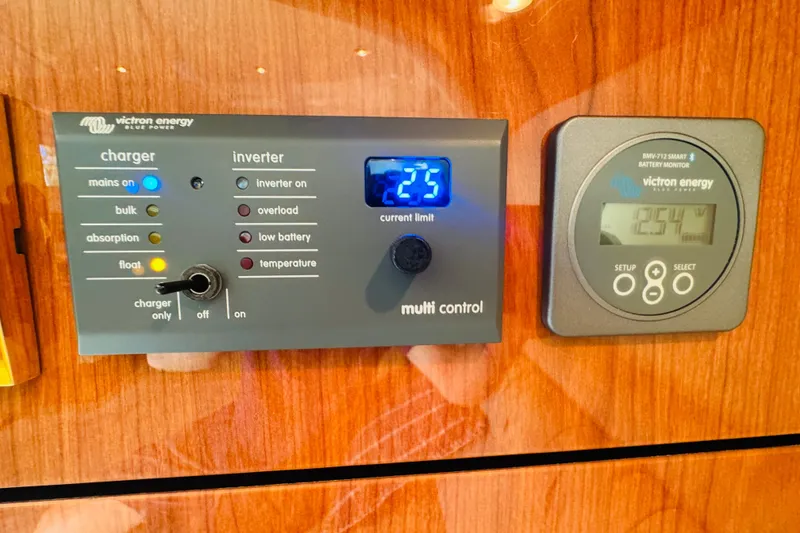 Slide: The Image of Control panel of a 2000 Sea Ray 400 Sedan Bridge with Victron Energy charger and inverter. - 54