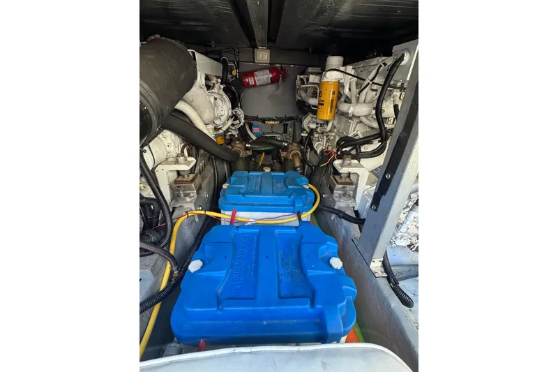 Slide: The Image of Engine compartment of a 2000 Sea Ray 400 Sedan Bridge with visible batteries and components. - 56