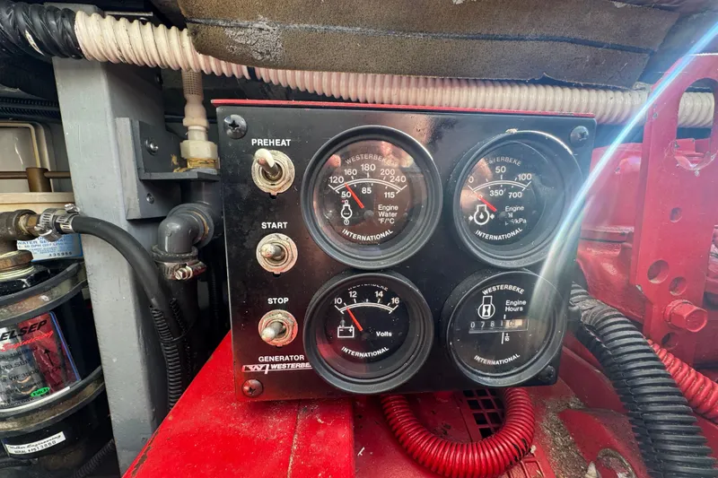 Slide: The Image of Control panel of a 2000 Sea Ray 400 Sedan Bridge with gauges and switches. - 60