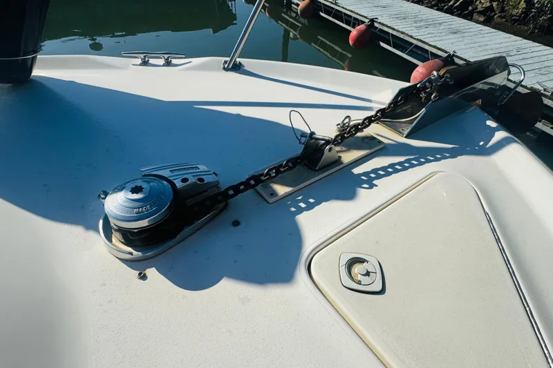 Slide: The Image of Anchor system on 2000 Sea Ray 400 Sedan Bridge yacht, docked by the water. - 8
