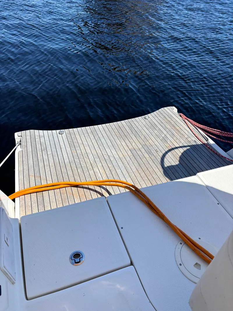 Slide: The Image of Stern platform of a 2016 Marlow-Hunter 37 yacht by the water. - 49