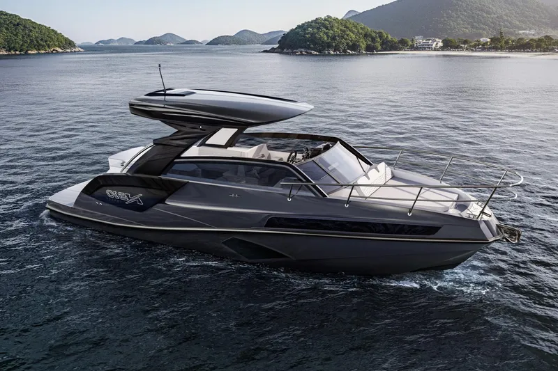 The Image of 2026 NX Boats NX310 luxury yacht cruising on serene waters with scenic island backdrop. - 1