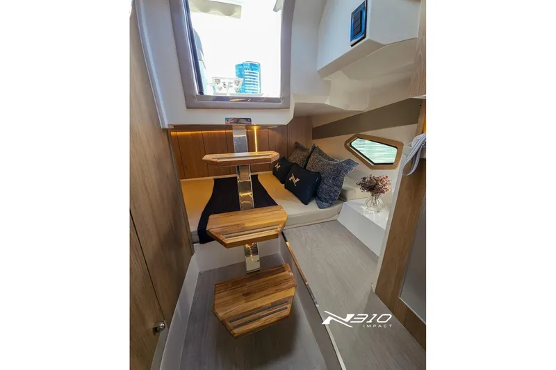 Slide: The Image of Luxurious interior of 2026 NX Boats NX310, featuring elegant wooden steps and cozy seating. - 8