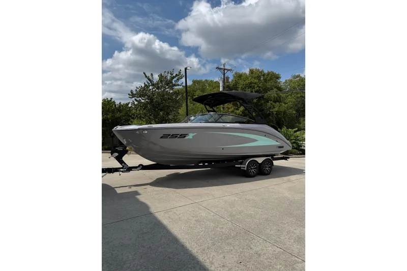 Slide: The Image of 2026 Yamaha Boats 255XD on trailer, parked outdoors under a cloudy sky. - 6