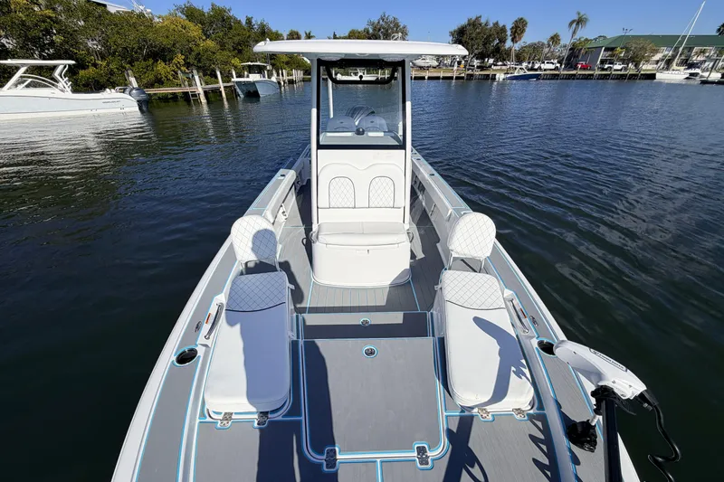Slide: The Image of 2022 Sportsman Masters 247 Bay Boat on calm water, featuring sleek design and comfortable seating. - 11