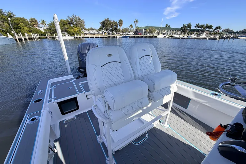 Slide: The Image of 2022 Sportsman Masters 247 Bay Boat with dual seats on a calm marina. - 12