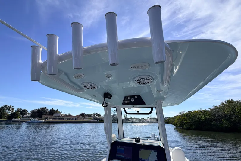 Slide: The Image of 2022 Sportsman Masters 247 Bay Boat with rod holders and electronics on a sunny day. - 14