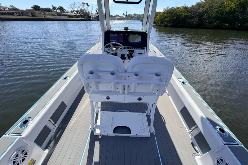 Slide: The Image of 2022 Sportsman Masters 247 Bay Boat interior with helm, seating, and water view. - 17