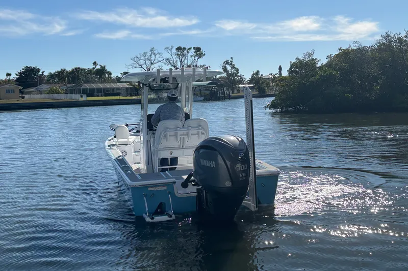 Slide: The Image of 2022 Sportsman Masters 247 Bay Boat cruising on a sunny waterway. - 7