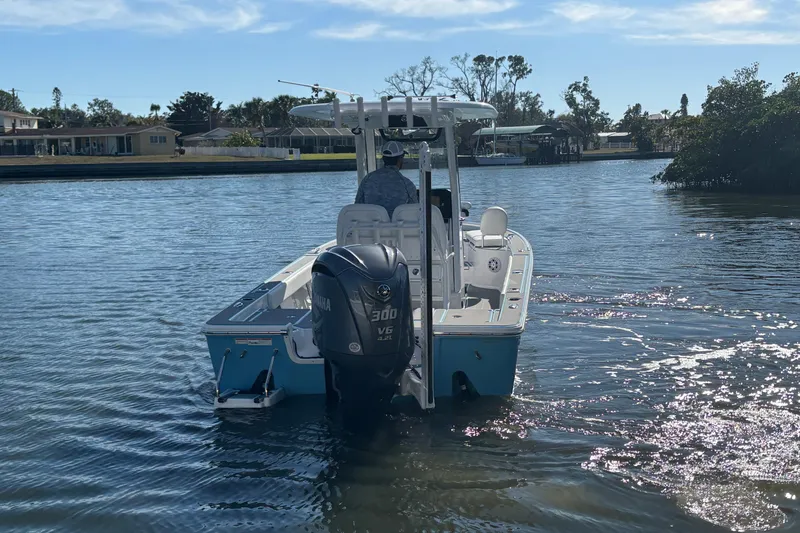 Slide: The Image of 2022 Sportsman Masters 247 Bay Boat cruising on a sunny waterway. - 8