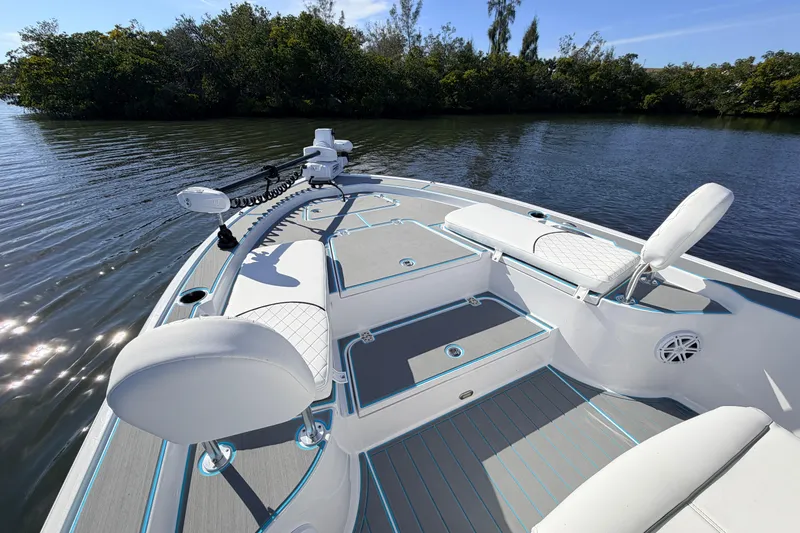 Slide: The Image of 2022 Sportsman Masters 247 Bay Boat interior with seating and fishing equipment. - 9