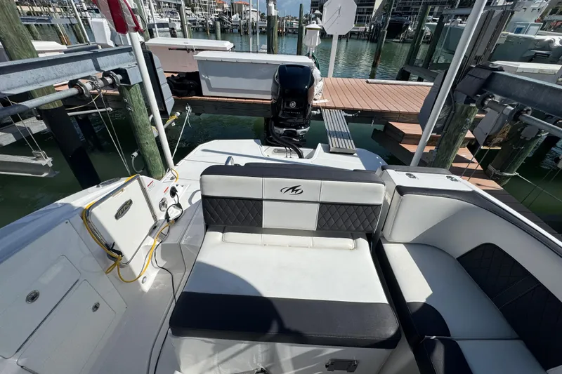 Slide: The Image of 2019 Monterey M-65 boat interior with seating and dock view. - 12