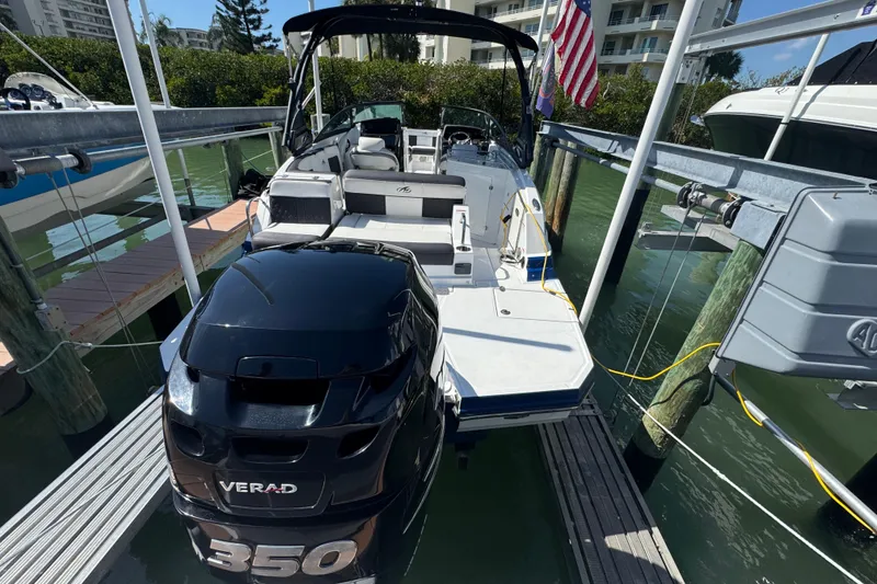 Slide: The Image of 2019 Monterey M-65 boat docked with Verado 350 engine, American flag displayed. - 14