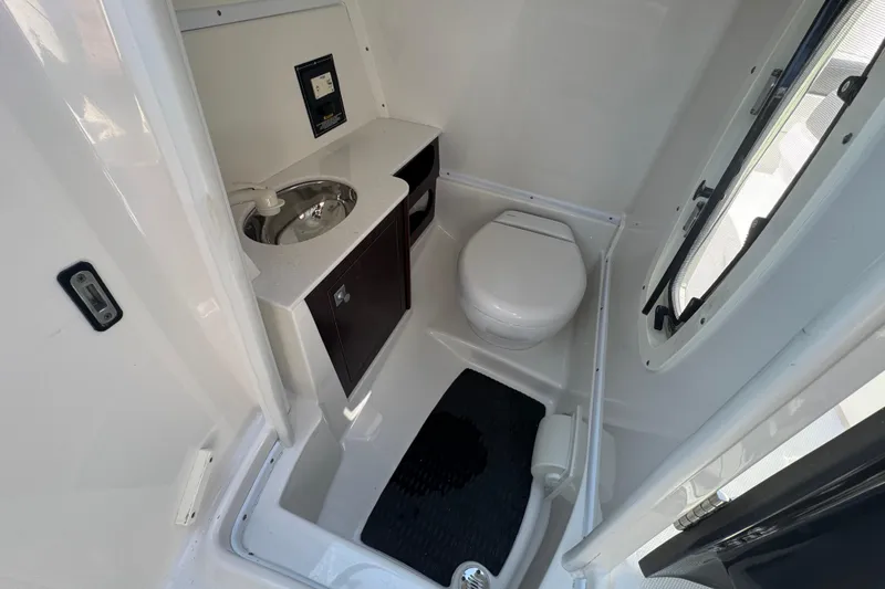 Slide: The Image of Compact bathroom in 2019 Monterey M-65 boat with sink, toilet, and window. - 18