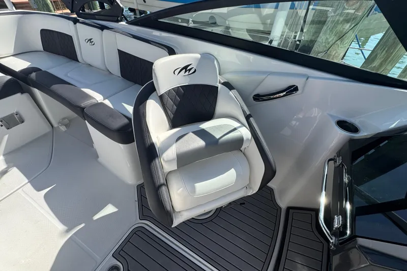 Slide: The Image of 2019 Monterey M-65 boat interior with black and white seating and sleek design. - 20