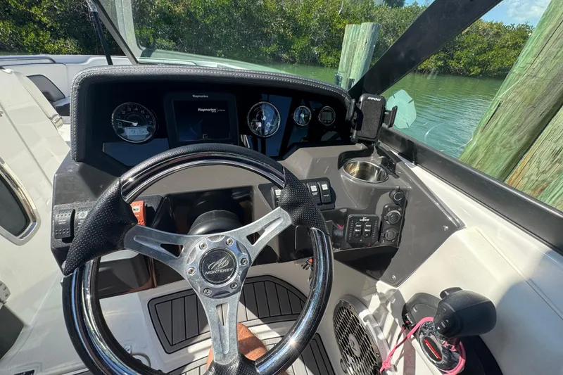 Slide: The Image of Cockpit view of 2019 Monterey M-65 boat with steering wheel and control panel. - 26