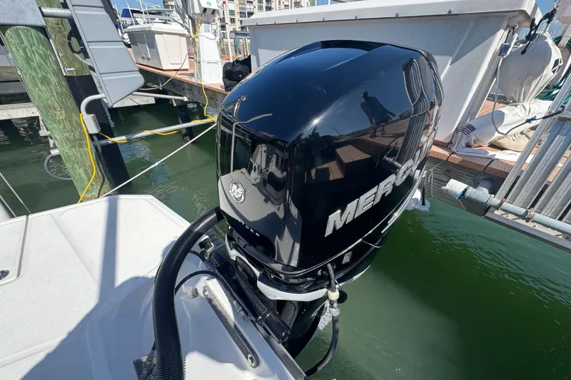 Slide: The Image of 2019 Monterey M-65 boat with a Mercury outboard motor at a marina dock. - 31