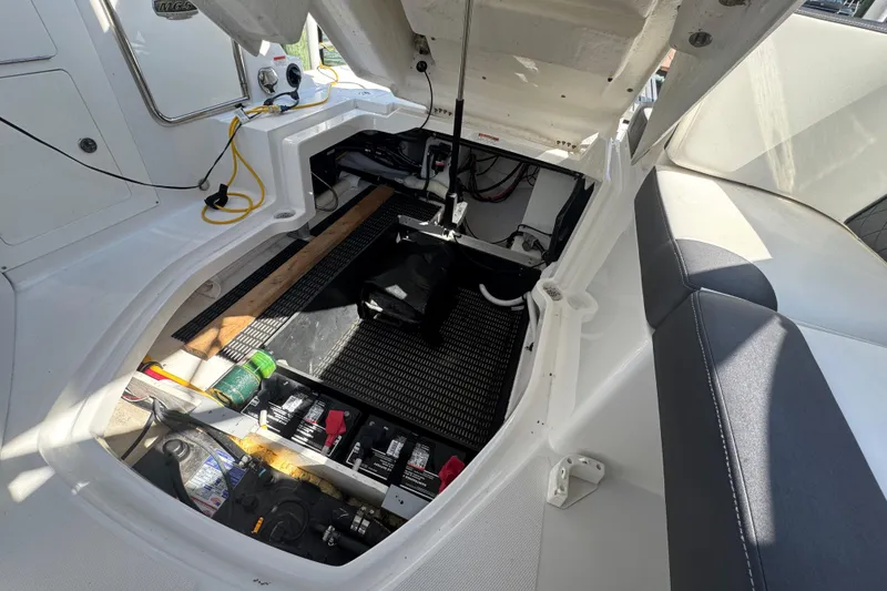 Slide: The Image of Open engine compartment of a 2019 Monterey M-65 boat, showing batteries and wiring. - 32