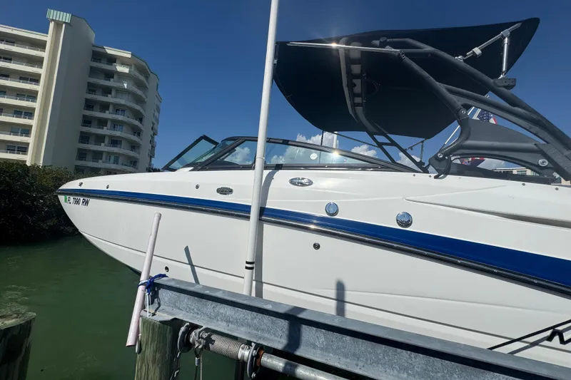 Slide: The Image of 2019 Monterey M-65 boat docked near waterfront buildings under clear blue sky. - 4