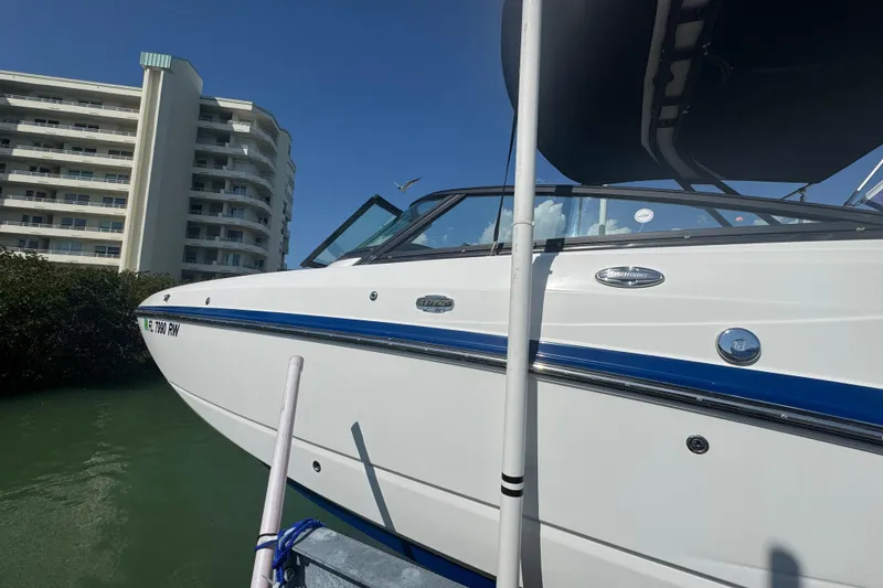 Slide: The Image of 2019 Monterey M-65 boat docked near a modern building under a clear blue sky. - 5