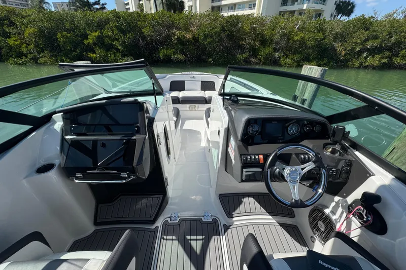 Slide: The Image of Interior view of a 2019 Monterey M-65 boat, featuring sleek dashboard and seating. - 8