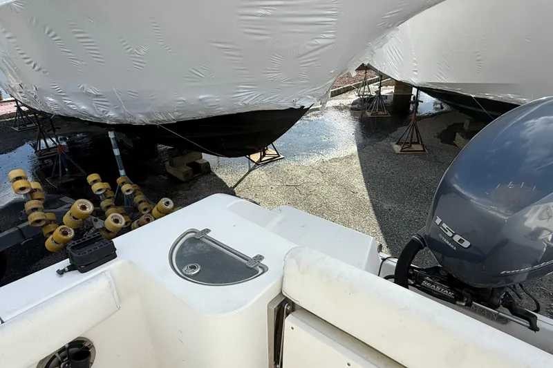 Slide: The Image of 2015 Sportsman Open 212 Center Console boat with Yamaha 150 engine in storage. - 12