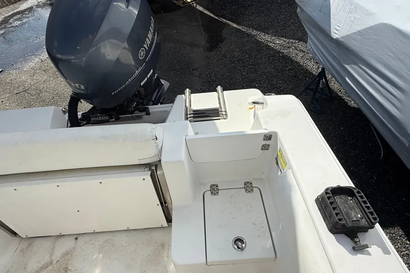 Slide: The Image of 2015 Sportsman Open 212 Center Console boat with Yamaha engine, rear seating, and storage area. - 13