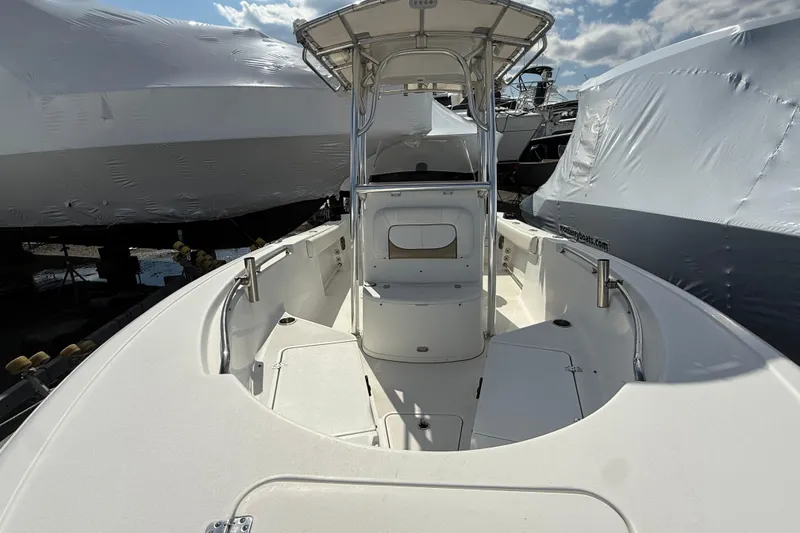 Slide: The Image of 2015 Sportsman Open 212 Center Console boat, docked, with clear skies above. - 2