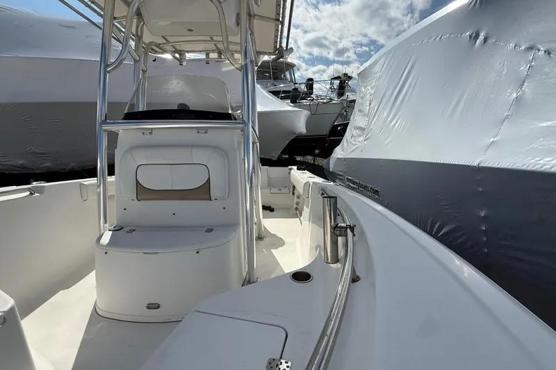 Slide: The Image of 2015 Sportsman Open 212 Center Console boat docked, surrounded by covered vessels. - 3