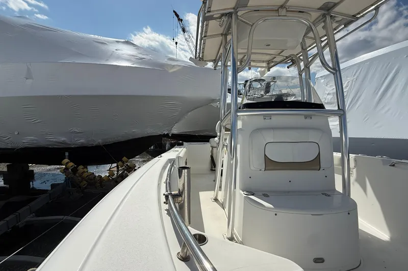 Slide: The Image of 2015 Sportsman Open 212 Center Console boat docked under clear sky. - 4