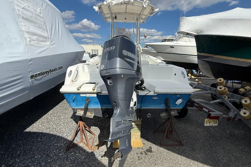 Slide: The Image of 2015 Sportsman Open 212 Center Console boat with Yamaha 150 engine in storage. - 6