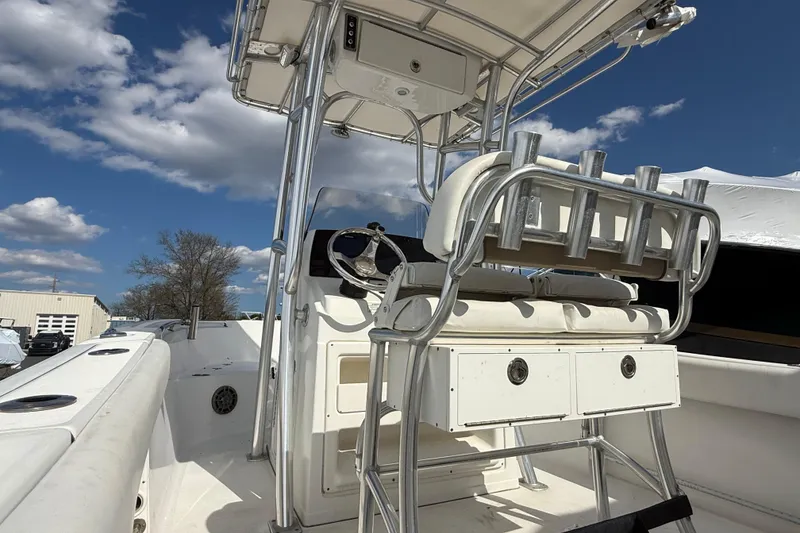Slide: The Image of 2015 Sportsman Open 212 Center Console boat interior with steering wheel and rod holders. - 8