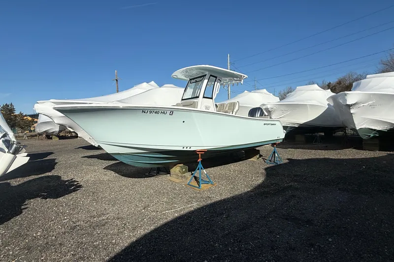 The Image of 2025 Sportsman Heritage 231 Center Console boat on stands, surrounded by covered boats. - 0