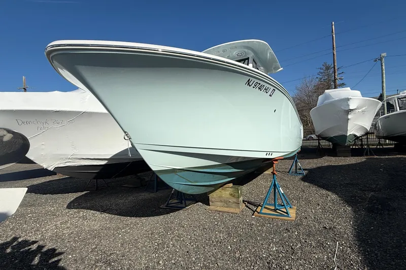 Slide: The Image of 2025 Sportsman Heritage 231 Center Console boat on stands, outdoor storage. - 3