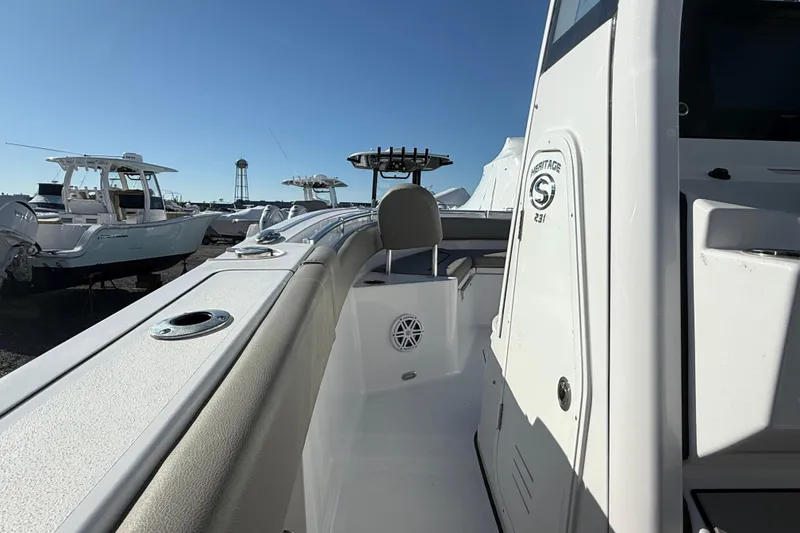 Slide: The Image of 2025 Sportsman Heritage 231 Center Console boat, docked under clear blue sky. - 9