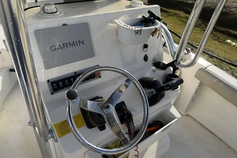 Slide: The Image of 2022 Key West 189 FS boat console with Garmin navigation system and steering wheel. - 12