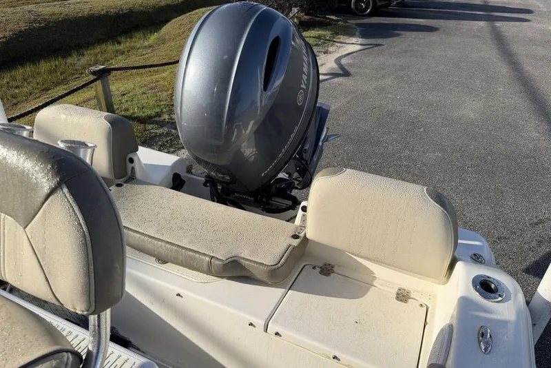 Slide: The Image of 2022 Key West 189 FS boat with Yamaha outboard motor, beige seating, and cup holders. - 8