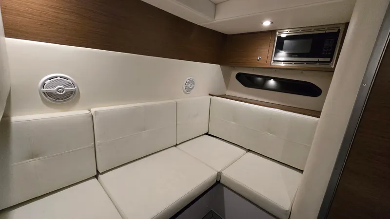 Slide: The Image of Interior of 2017 Cruisers Yachts 338CX with white sofa and microwave. - 24