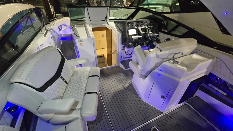 Slide: The Image of Interior of a 2017 Cruisers Yachts 338CX with luxurious seating and helm console. - 5