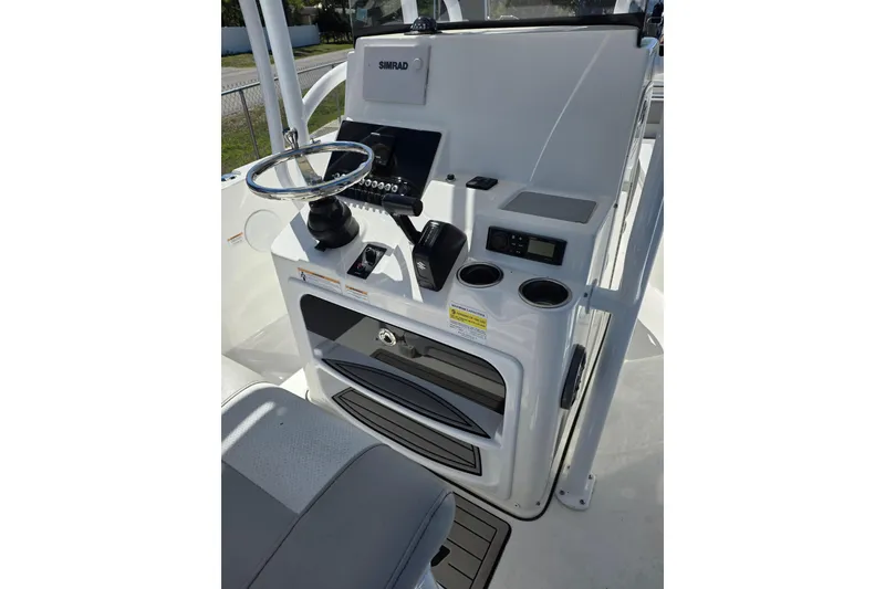 Slide: The Image of 2018 Sea Pro 219 Center Console boat dashboard with steering wheel and controls. - 11